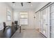 Bright office with large desk, ceiling fan, sliding doors, and windows, offering a versatile workspace at 2853 Yosemite St, Denver, CO 80238