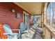 Inviting front porch featuring comfortable seating, wood flooring, and an entrance to the house at 2853 Yosemite St, Denver, CO 80238