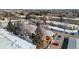 Aerial view of townhomes with snow-covered roofs and tree-lined streets at 705 S Clinton # 2A, Denver, CO 80247