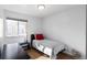 Bright bedroom with a twin bed, side table, and a window at 705 S Clinton # 2A, Denver, CO 80247