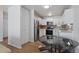 Well-lit kitchen featuring stainless steel appliances, white cabinetry and stylish eat-in area at 705 S Clinton # 2A, Denver, CO 80247