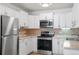 Galley-style kitchen with stainless steel appliances, modern finishes, and plenty of storage space at 705 S Clinton # 2A, Denver, CO 80247