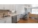 Well-lit kitchen featuring stainless steel appliances, granite counters, and wood flooring at 705 S Clinton # 2A, Denver, CO 80247