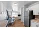 Bright living area with hardwood floors, ladder shelving, and lots of light from the sliding glass door at 705 S Clinton # 2A, Denver, CO 80247