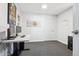 Bright office room features a desk and monitors, gray carpet, and art at 1050 S Quitman St, Denver, CO 80219