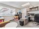 Office with wall art, desk, multiple monitors, a gray carpet and a large window at 1050 S Quitman St, Denver, CO 80219