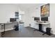 Office room featuring multiple monitors, gray carpet and a view from an adjacent room at 1050 S Quitman St, Denver, CO 80219