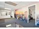 Office space featuring a mural, gray carpet floor, and a view to another office at 1050 S Quitman St, Denver, CO 80219