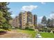 Multi-story condo building featuring balconies and manicured green spaces on a sunny day at 14300 E Marina Dr # 512, Aurora, CO 80014
