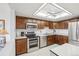 Kitchen with stainless steel appliances, stainless steel sink and wood cabinets at 14300 E Marina Dr # 512, Aurora, CO 80014