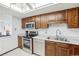 Bright kitchen with stainless steel appliances, wood cabinets, and overhead lighting at 14300 E Marina Dr # 512, Aurora, CO 80014