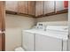 Laundry room with washer, dryer, shelving, and hanging hooks for extra space at 14300 E Marina Dr # 512, Aurora, CO 80014