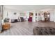 Bright and airy living room showcasing open floor plan, kitchen access, and wood-look floors at 14300 E Marina Dr # 512, Aurora, CO 80014