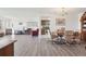 Open-concept living area with laminate flooring, dining space, and a glimpse into the kitchen at 14300 E Marina Dr # 512, Aurora, CO 80014