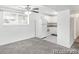 Efficient white kitchen in open-concept unit, featuring new appliances and a ceiling fan at 1723 Robb St # 44, Lakewood, CO 80215
