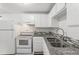 Efficient kitchen featuring granite counters and white appliances at 1723 Robb St # 44, Lakewood, CO 80215