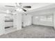 Bright living room featuring neutral walls and carpet, flowing into an updated kitchen at 1723 Robb St # 44, Lakewood, CO 80215