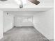 The large living room features a ceiling fan, carpet flooring, and a painted brick accent wall at 1723 Robb St # 44, Lakewood, CO 80215