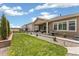Well-maintained backyard with a covered patio, barbecue area, and lush lawn, perfect for relaxation at 228 Rogers Ct, Castle Rock, CO 80104