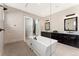Bright bathroom featuring a walk-in shower, a soaking tub, and a granite-topped double vanity at 228 Rogers Ct, Castle Rock, CO 80104