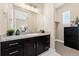 Bathroom featuring dark wood cabinets, a gray countertop, and a view into the Primary bedroom at 228 Rogers Ct, Castle Rock, CO 80104