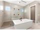 Modern bathroom showcasing a walk-in shower with tile surround and a soaking tub at 228 Rogers Ct, Castle Rock, CO 80104