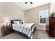 Well-lit bedroom with a ceiling fan, a large window, and wood furniture at 228 Rogers Ct, Castle Rock, CO 80104