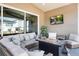 Comfortable covered patio seating area with modern outdoor fireplace and mounted tv at 228 Rogers Ct, Castle Rock, CO 80104