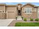A charming home with a mix of stone and siding, complemented by a well-manicured lawn and landscaping at 228 Rogers Ct, Castle Rock, CO 80104