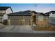 Charming two-story home with a three-car garage and stone accents, offering curb appeal at 228 Rogers Ct, Castle Rock, CO 80104