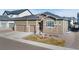 Charming two-story home featuring a three-car garage with stone accents and a well manicured lawn at 228 Rogers Ct, Castle Rock, CO 80104
