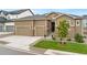 A beautiful home with a three car garage, landscaped front yard, and manicured lawn at 228 Rogers Ct, Castle Rock, CO 80104