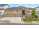 Charming home with a three-car garage, stone accents, landscaped yard, and inviting front entrance at 228 Rogers Ct, Castle Rock, CO 80104