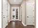 Hallway boasting wood floors, white trim, and access to various rooms through multiple white doors at 228 Rogers Ct, Castle Rock, CO 80104