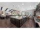 Open-concept kitchen with a spacious island, stainless steel sink, and dark cabinetry at 228 Rogers Ct, Castle Rock, CO 80104