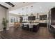 Spacious kitchen featuring dark wood cabinets, an oversized island, pendant lighting and a dining area at 228 Rogers Ct, Castle Rock, CO 80104