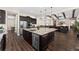 Open kitchen featuring a large island, stainless steel appliances, and hardwood floors at 228 Rogers Ct, Castle Rock, CO 80104