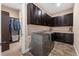 Beautiful laundry room with wood floors, lots of cabinets, and stainless steel appliances at 228 Rogers Ct, Castle Rock, CO 80104