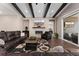 Living room with modern fireplace, wood beams, and adjacent walkout to a porch at 228 Rogers Ct, Castle Rock, CO 80104