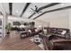 Open concept living room with beamed ceilings, hardwood floors and an adjacent kitchen at 228 Rogers Ct, Castle Rock, CO 80104