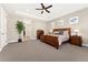 Spacious bedroom with a trey ceiling, large bed, and a glimpse into the en-suite bathroom at 228 Rogers Ct, Castle Rock, CO 80104