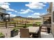 Outdoor dining area with wicker table and chairs, overlooking a grassy expanse with scenic views at 228 Rogers Ct, Castle Rock, CO 80104