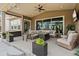 Inviting covered patio with comfortable seating, fire pit, and ceiling fan, perfect for outdoor entertaining at 228 Rogers Ct, Castle Rock, CO 80104