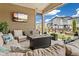 Relaxing outdoor space with a cozy fire pit, plush seating, and a mounted TV for entertainment at 228 Rogers Ct, Castle Rock, CO 80104
