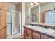 Bathroom with a double sink vanity, a shower with glass doors, and tile flooring at 7971 Larkspur Cir # 219, Frederick, CO 80530