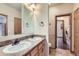 Bathroom featuring a double sink vanity, a large mirror, tile floors and a separated toilet space at 7971 Larkspur Cir # 219, Frederick, CO 80530