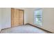 Bedroom with a closet, carpet, and natural light streaming through a window at 7971 Larkspur Cir # 219, Frederick, CO 80530