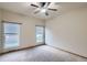 Bright bedroom featuring neutral carpet, a ceiling fan and two windows with views at 7971 Larkspur Cir # 219, Frederick, CO 80530