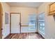 Inviting entryway features wood floors, a white door, and natural light streaming through the windows at 7971 Larkspur Cir # 219, Frederick, CO 80530