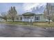 Charming single-story home features a welcoming front porch and well-maintained lawn with flowering trees at 7971 Larkspur Cir # 219, Frederick, CO 80530